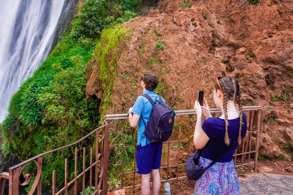 A couple taking souvenir fotos of the Ouzoud Waterfall