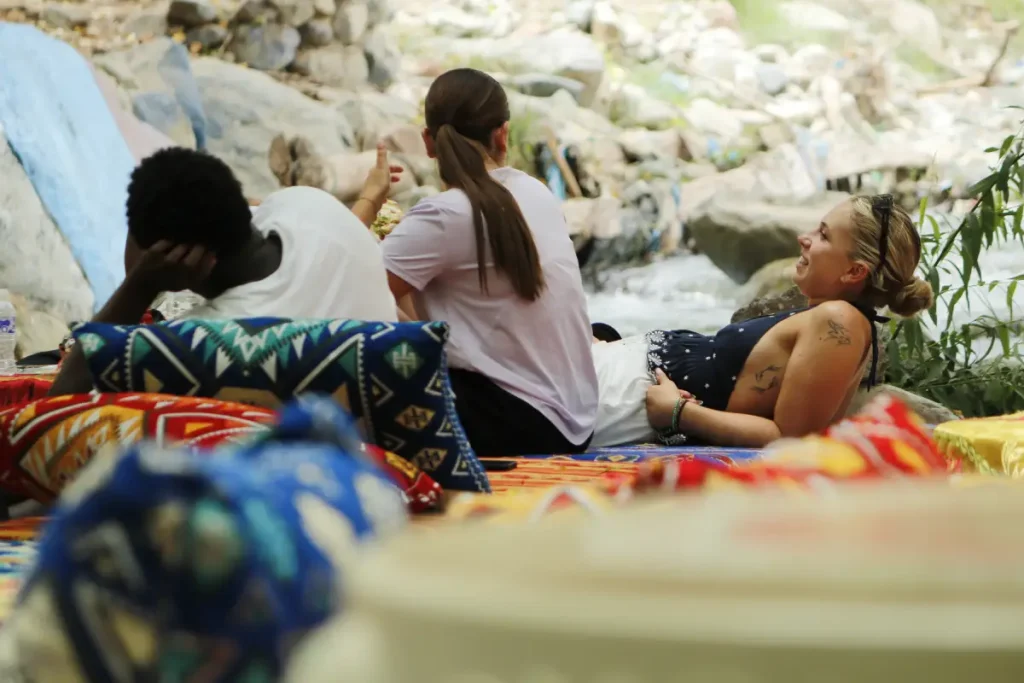 Girls Resting Across the Riverbanks