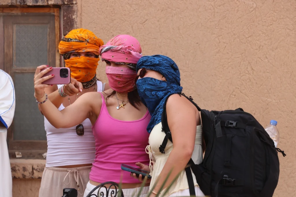 What to pack for the Sahara Desert, a traveller in light layers on the dunes